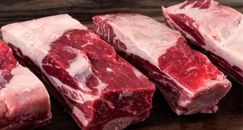 "Fresh raw beef short ribs ready for seasoning and cooking, perfect for a recipe with oxtail seasoning."

